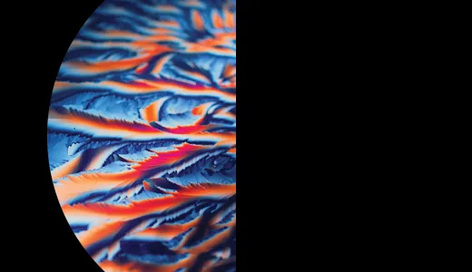 A semi-circle on a black background, featuring vibrant blue, orange, and red swirls 