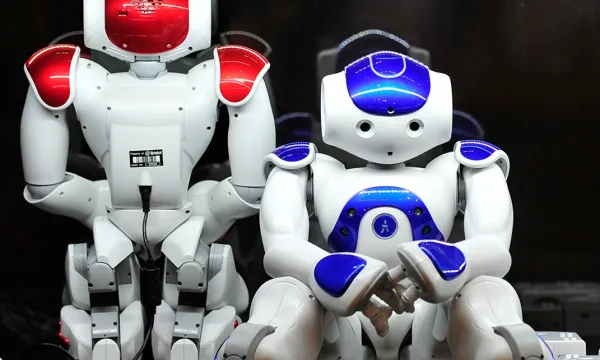 Two Nao robots - small white humanoid form with read and blue colouring