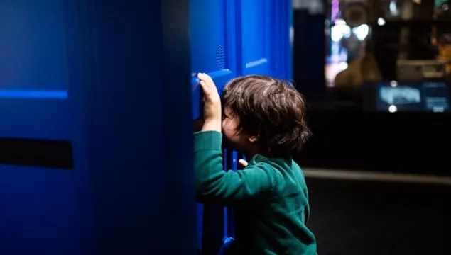A child peering into the TARDIS