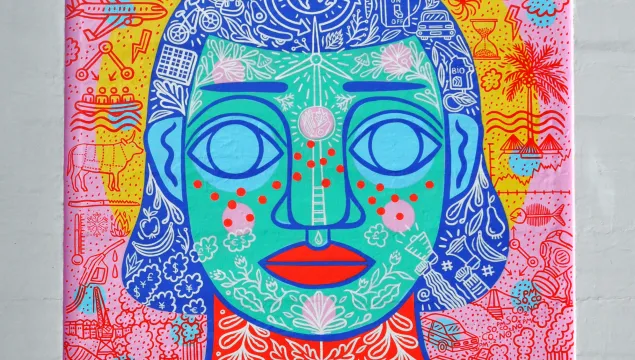 Brightly coloured mural of a person's face