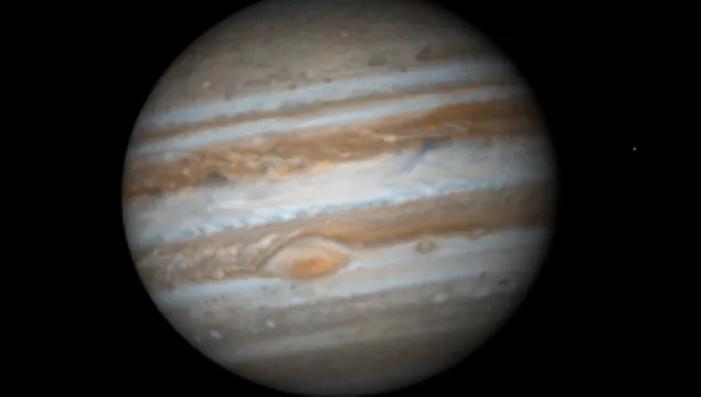 Photograph of Jupiter.  Coloured bands of gas and the great red spot visible.